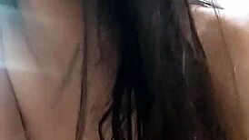 Amateur video with a young woman in an intimate setting.