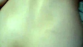 Amateur video with a young woman in an intimate setting.