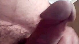 The bear guy jerks off with his huge cock, moaning loudly.