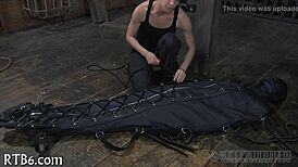 Hey, what’s this restrained girl getting punished for in the garage?