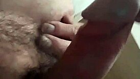 The bear guy jerks off with his huge cock, moaning loudly.