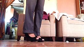 Shemale struts in black high heels, teasing with every bold step