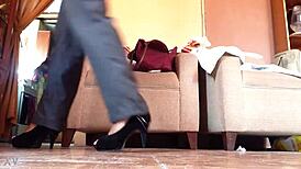 Shemale struts in black high heels, teasing with every bold step