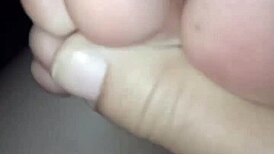 a slut shows her bare feet in the dark