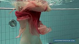 Katya Okuneva looks stunning in her red dress by the pool.