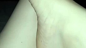 a slut shows her bare feet in the dark