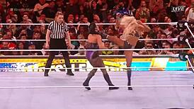 rhea ripley battles charlotte flair in a intense wrestling match at wrestlemania
