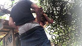 In the backyard, fucking the redhead's ass like a sex toy.