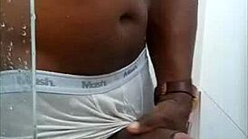 Black guy casually rubs his huge cock outdoors in public