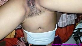 Brunette woman rubs her hand on vagina intensely