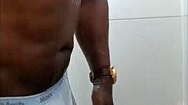 Black guy casually rubs his huge cock outdoors in public