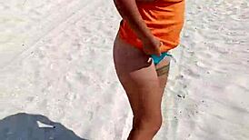 Wow, check out this horny Mexican slut flashing her thong and natural tits right on a public beach!