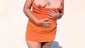 Wow, check out this horny Mexican slut flashing her thong and natural tits right on a public beach!