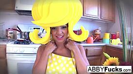 Surreal kitchen dress up scene with Abigail and her giant cucumber.