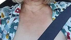 Naughty housewife takes homemade selfie with exposed tits in the car.