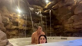 Couple enjoying honeymoon in motel, wife relaxing by the pool with a fun ride.