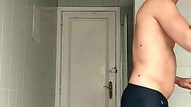 sexy guy shaving in black beach shorts