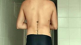 sexy guy shaving in black beach shorts