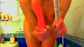 Tattooed Model Fingers Pussy With Glass Dildo In Bathroom