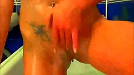 Tattooed Model Fingers Pussy With Glass Dildo In Bathroom