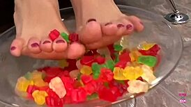 Kinky brunette using gummy bears for footjob fun