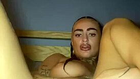 Tattooed goth woman fingers herself