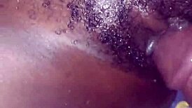 Teasing her hairy beaver with a monster black cock before penetration