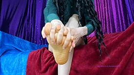 Mistress Rebecca Diamante massaging her feet right now