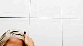 milf in bathroom slides dildo into shaved pussy