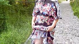 Hairy mature woman wears transparent dress outdoors