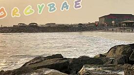 Couple having fun playing voyeur at the public bar and beach