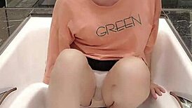 shemale ting xuan bathes in the bathtub while clothed