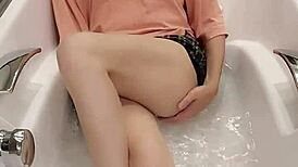shemale ting xuan bathes in the bathtub while clothed