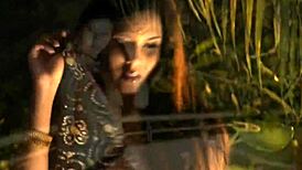 brunette indian woman dances sensually while undressing