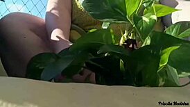 Naked Woman Waters Plants on Balcony for Curious Viewers