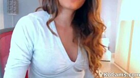 shy brunette teases naked on webcam with fake tits.