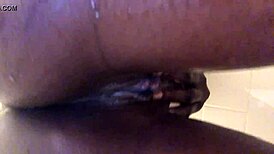 Black woman exposes her asshole while playing in the water