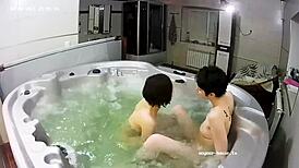 young lesbian couple takes bath and fingering in jacuzzi