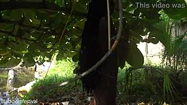 Naked Skinny Tribe Woman Making A Bow To Go Hunting