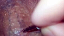 Detailed solo masturbation showcasing massive pierced cock with multiple holes