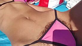 Skinny Latina teases flashing hairy pussy and small tits barefoot on public beach