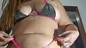 her swollen pussy stretches the tiny bikini in solo flashing tease