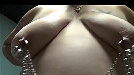 double pierced fat wife chained up with heavy barbells and bondage pulling on huge nipples