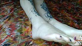i oil up my tattooed feet and stroke your cock with perfect footjob grips