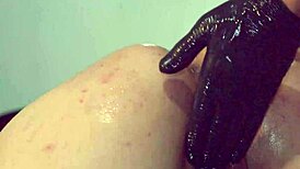 porno slut bends over as gloved fist stretches her pussy and ass wide open