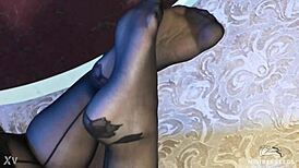 Sexy pantyhose goddess teases feet in rose print heels close-up