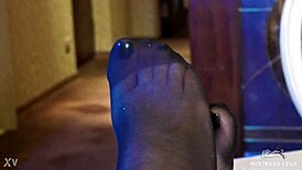 Sexy pantyhose goddess teases feet in rose print heels close-up