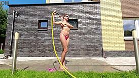 pink bikini gets soaked in the hose outside garden shower wet pussy play