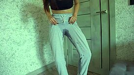 desperate student pisses sweatpants then rubs big clit pussy lips