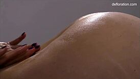 Jennifer Lorentz massages virgin babe's shaved pussy legs wide